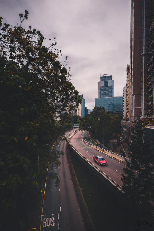 Red taxi Cruising through Tsim Sha Tsui, Kowloon, Hong Kong, China.  Fine Art Limited Edition of 28. Photo © Copyright by Sylvère Clerempuy.