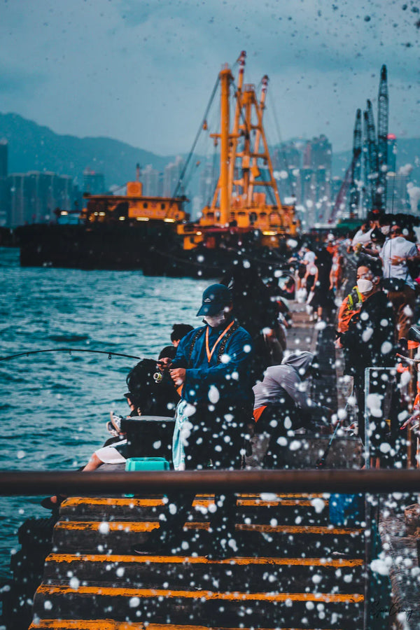 Local fisher man fishing in a burst of foam in Kennedy Town, hong Kong, China.  Fine Art Limited Edition of 28. Photo © Copyright by Sylvère Clerempuy.