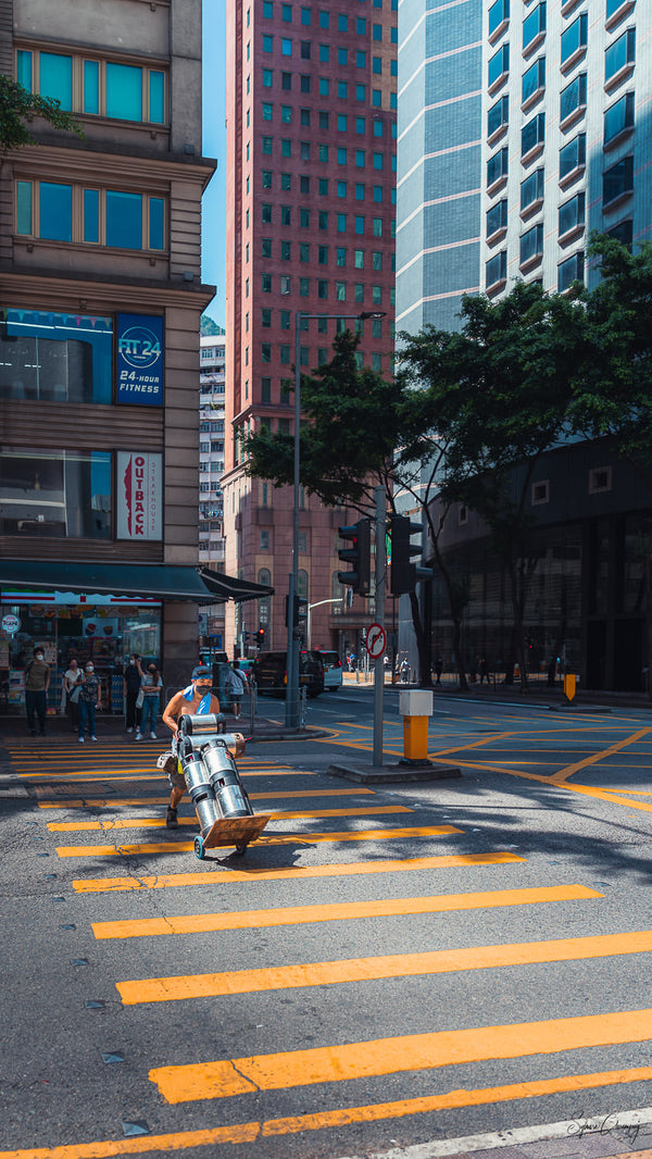 Street photography shot of a worker on duty in the morning in Wanchai, Hong Kong.  Fine Art Limited Edition of 28. Photo © Copyright by Sylvère Clerempuy.
