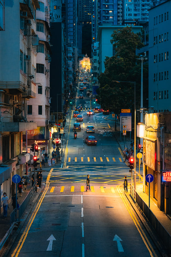 Street photography shot of a man crossing Western Street at dusk in San Ying Pun, Hong Kong  Fine Art Limited Edition of 28. Photo © Copyright by Sylvère Clerempuy.